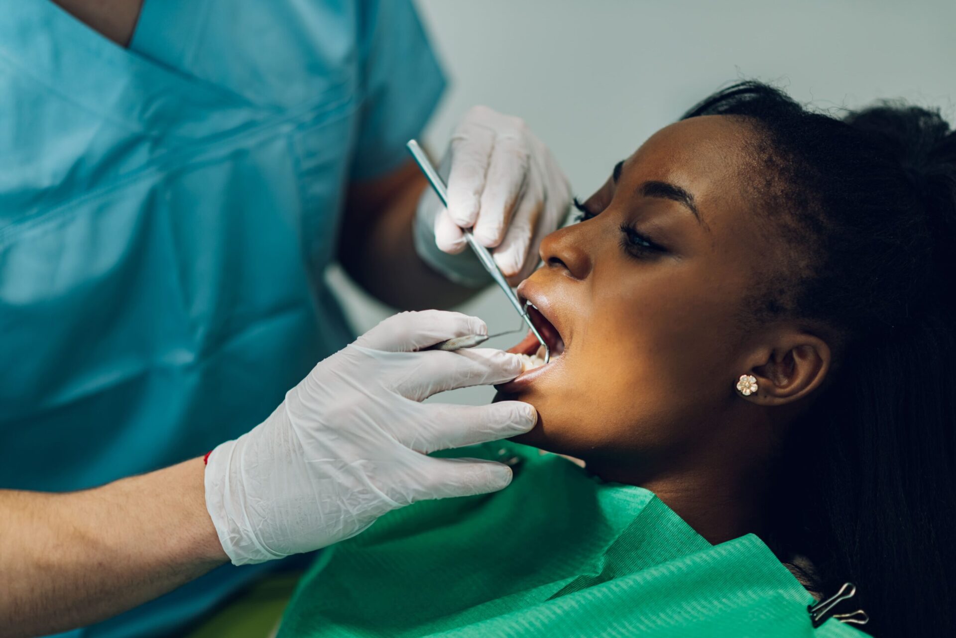 dentist-providing-dental-care-treatment-to-a-afric-2022-05-24-00-00-31-utc (1)