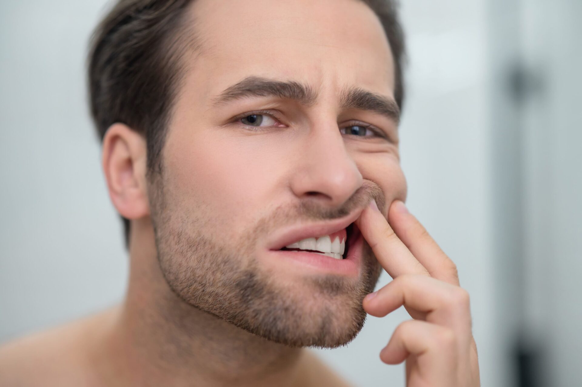 man-checking-his-teeth-and-looking-disturbed-2021-12-16-22-14-49-utc (1)