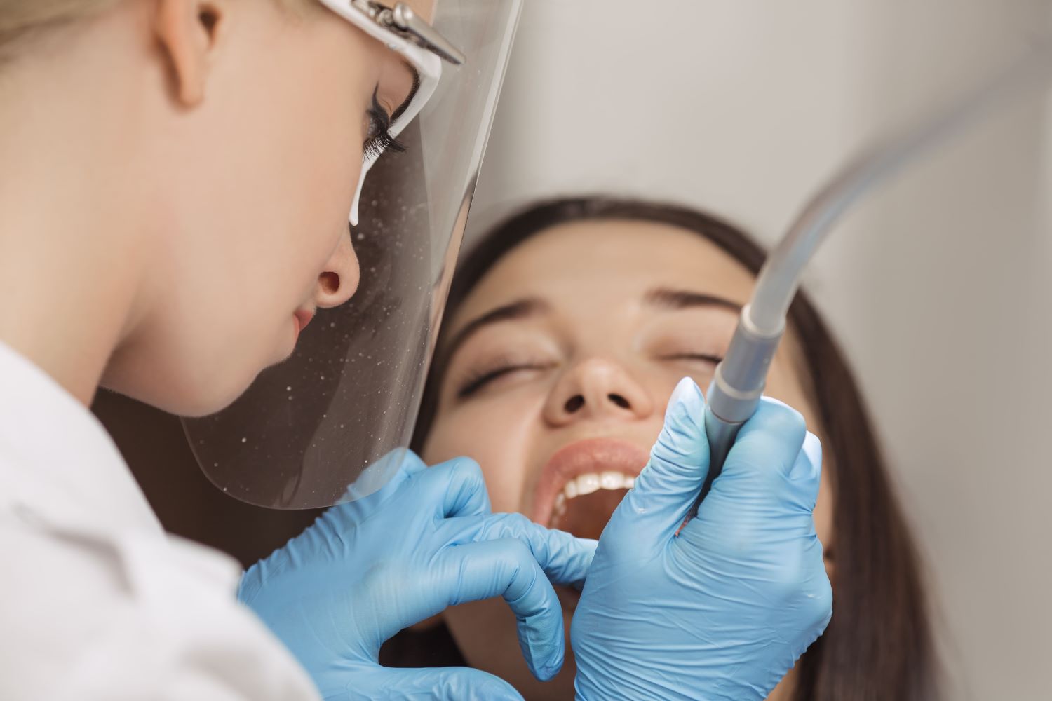dentist-doing-a-dental-treatment-on-a-female-patie-2022-05-26-21-49-28-utc