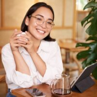 smiling-asian-girl-in-glasses-woman-working-on-re-2022-11-09-05-52-57-utc (1)