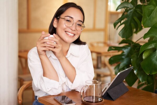 smiling-asian-girl-in-glasses-woman-working-on-re-2022-11-09-05-52-57-utc (1)