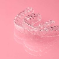 two-invisible-dental-teeth-aligners-on-the-pink-ba-2021-10-01-19-42-33-utc (1)